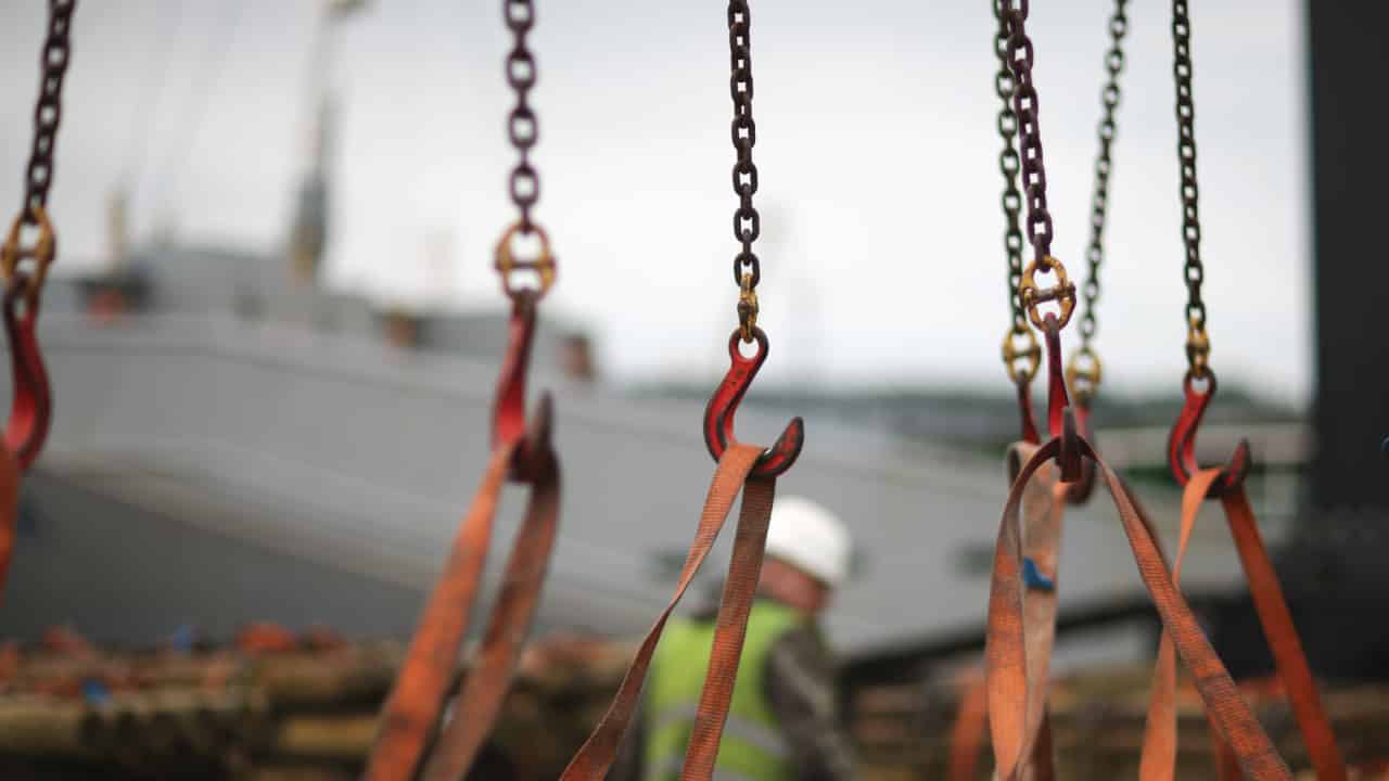 An image of a series of chains, hooks, and synthetic slings used for banner for Southwest Wire Rope blog "When to Remove a Synthetic Sling from Service"