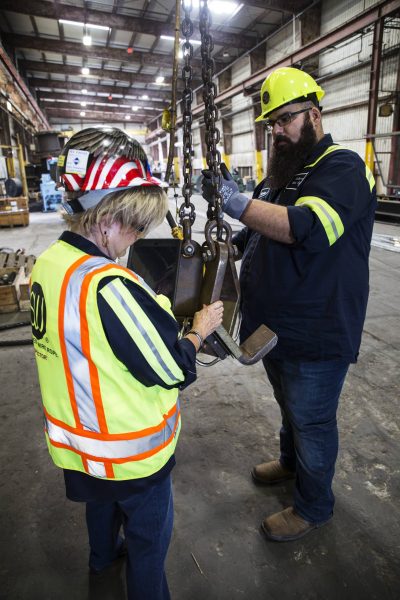 Employees at Southwest Wire Rope testing chains during on site inspection